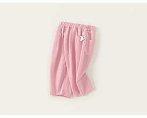 Detailed texture of pink cotton linen pants showing elastic waist and side pockets