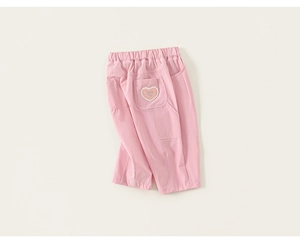 Detail of light pink kids trousers showing the elastic waist and heart-shaped pocket design