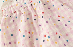 Détail du pantalon rose à carreaux pour fille avec pois colorés et taille élastique