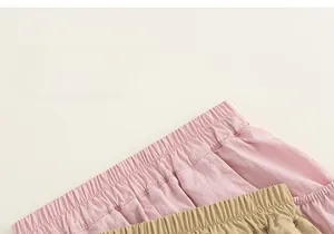 Detail of high-elastic waistbands on pink and khaki summer cotton cargo shorts