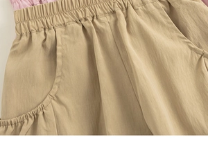 Detailed view of kids cargo shorts with elastic waistband and deep side pockets