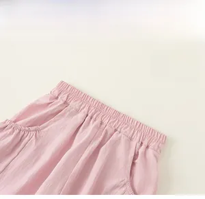 Detail of children's pink cargo pants with elastic waistband and side pockets