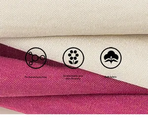 Detailed macro view of soft pink and beige cotton fabric texture with heavy canvas weave
