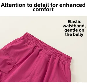 Detail of the elastic waistband on magenta cargo shorts featuring textured nylon fabric