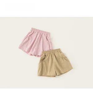 Detail view of pink and khaki cotton shorts with elastic waistband and large side pockets