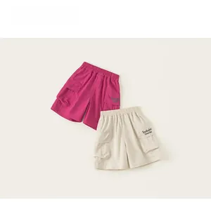 Detail of kids cargo shorts with elastic waist and letter embroidery on pockets