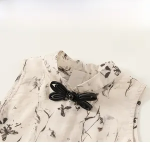 Detail of mandarin collar with traditional ink butterfly print and handmade frog closure