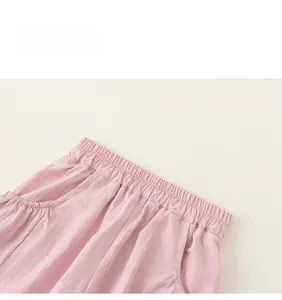 Detail view of pink cargo shorts featuring an elastic waistband and functional pockets