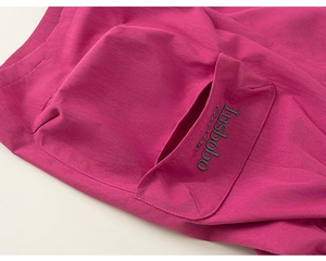 Detail of rose red cargo shorts showing fine woven fabric and black letter embroidery