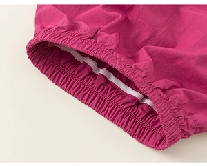 Macro detail of elastic waistband on purple cargo shorts with neat stitching and fabric texture