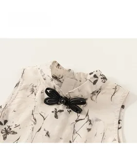 Detail of Chinese style mandarin collar with black butterfly bow and ink print fabric
