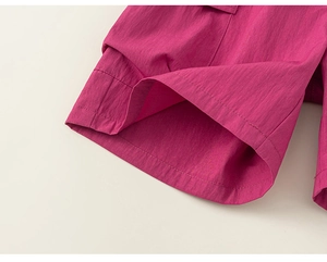 Detailed close-up of pink cargo shorts featuring high-quality stitching and nylon fabric