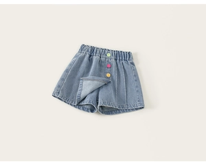 Dettaglio della gonna-pantalone in denim azzurro con vita elastica e tre bottoni colorati