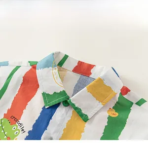 Close-up of boys' colorful striped shirt with crocodile print and bright green buttons
