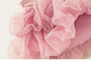 Detail of pink tutu dress showing rib knit bodice and layered soft mesh tulle texture