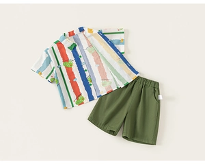 Flat lay of boys cotton summer set featuring colorful striped shirt with crocodile print