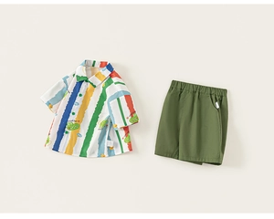 Close-up of boys' summer set featuring a colorful striped shirt with cartoon crocodiles