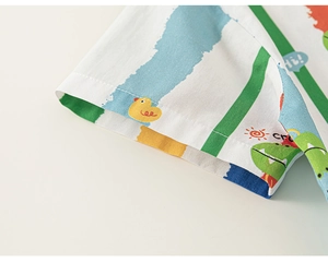 Detailed close-up of boy's shirt sleeve with colorful duck and dinosaur print