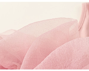 Detail of pink layered tulle mesh and ribbed knit fabric on summer dress for girls