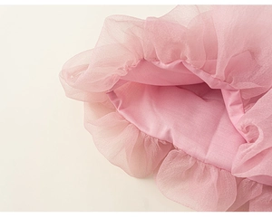 Detailed view of layered pink mesh fabric and ruffled hem on a girls tutu dress