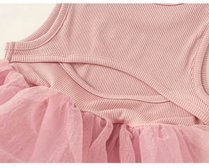 Detail of pink summer dress featuring ribbed knit top, tutu mesh skirt and oval back cutout