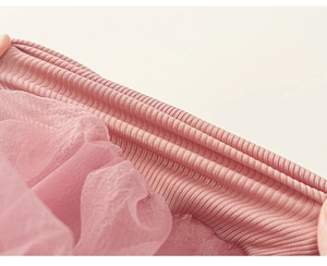 Detailed macro view of pink elastic ribbed waistband and layered tulle tutu fabric