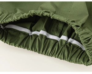 Detail of olive green cotton shorts featuring an elastic waistband and white drawstring