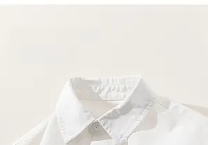 Detail of a white cotton shirt showing the lapel collar and delicate stitching work