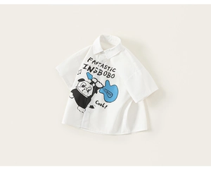 Close-up of a white short-sleeve shirt for boys featuring a cool cartoon dog print