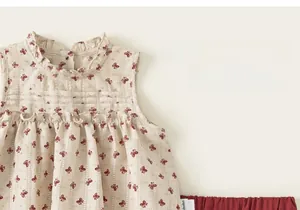 Close-up of ruffled high collar and red butterfly print on sleeveless girls' blouse