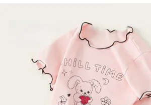 Nahaufnahme des rosa Baumwoll-T-Shirts mit Hasenprint und dekorativen Rüschenkanten