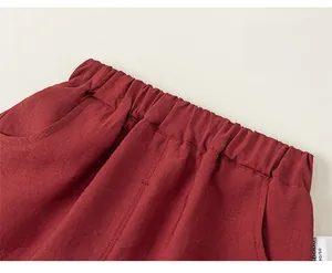 Detail of red cotton linen shorts showing elastic waistband and high-quality stitching