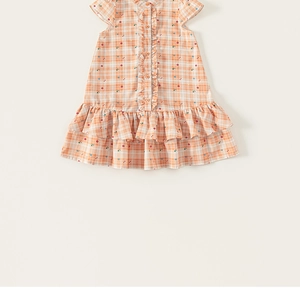 Detail of cotton plaid summer dress featuring orange checks and floral ruffles