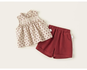 Detailed close-up of girls floral sleeveless top with ruffled collar and solid shorts set
