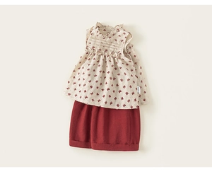 Detailed close-up of floral sleeveless cotton top with ruffled collar and red shorts set
