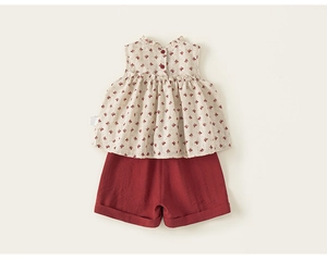Detail of floral ruffle sleeveless top and red shorts set in breathable cotton fabric
