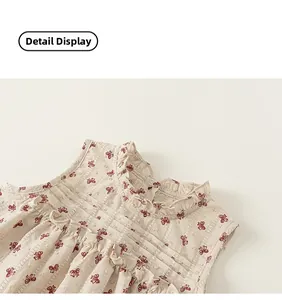 Detail of child's cream cotton blouse with red bow print and ruffled frill collar