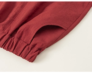 Detailed macro view of deep red cotton linen fabric with elastic waistband and side pocket
