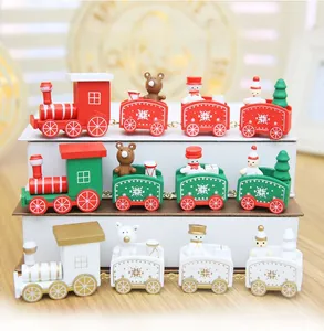 Detailed close-up of three wooden Christmas trains in red, green, and white holiday colors