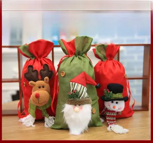 Detailed view of Christmas drawstring gift bags featuring reindeer, Santa, and snowman designs