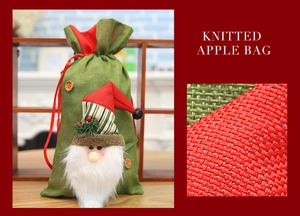 Detail of green knitted Christmas gift bag featuring a 3D Santa Claus and red drawstring