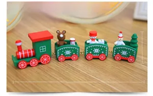 Detail of wooden Christmas train with snowman and bear figures on wooden surface