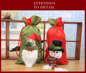 Detailed view of Christmas drawstring gift bags with plush Santa and snowman dolls