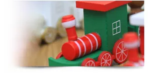 Macro shot of natural solid wood Christmas train detail with red and green finish