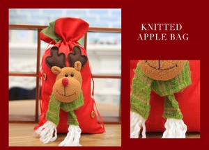 Detail of red Christmas reindeer gift bag with soft 3D doll and green striped scarf