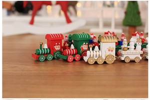 Detailed view of red and green painted wooden Christmas train with miniature Santa and snowman