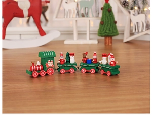 Detail of wooden Christmas train with Santa, snowman, and gifts on a festive desk