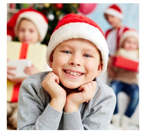 Detailed view of kids' plush red Santa hat with soft faux fur trim and white pompom