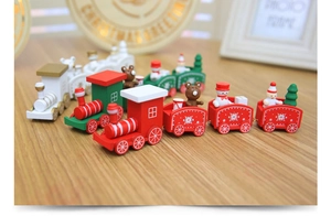 Detailed view of miniature wooden Christmas train set with snowman and festive tree decor