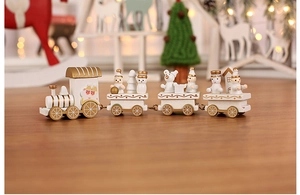 Detailed view of white and gold wooden Christmas train with snowman figures on a table